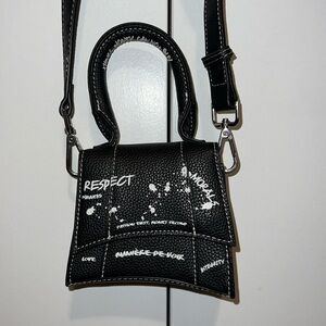 Black mini bag. Powerful message